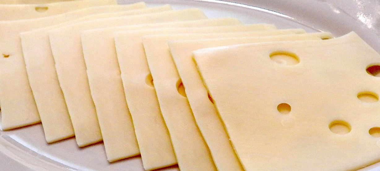 Swiss cheese stacked on a plate