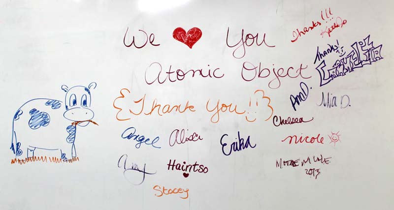 A note written on whiteboard: "We (heart) You Atomic Object. Thank you!"
